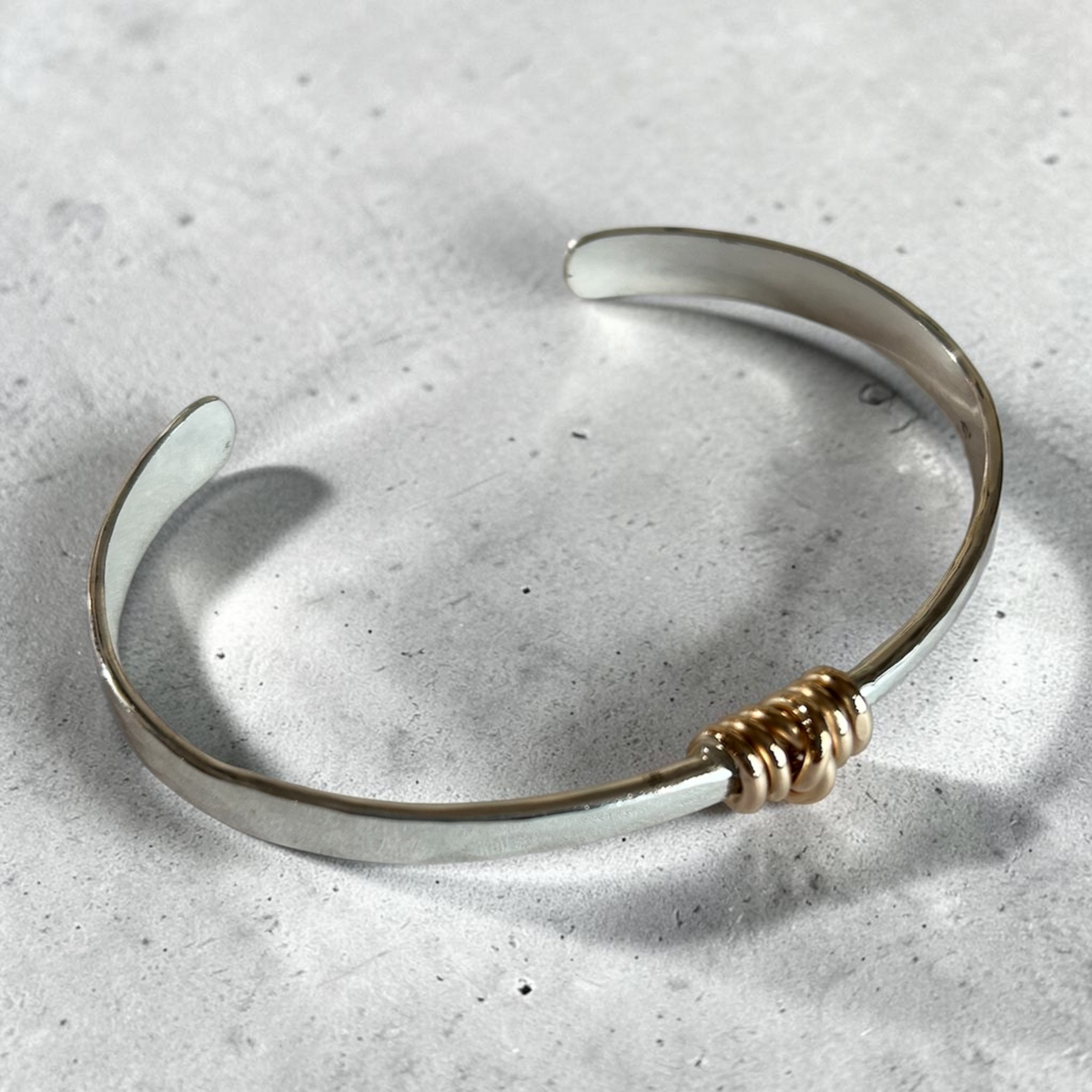 Silver Bracelet with Gold Knot by Sausalito Precious Metals Inc.