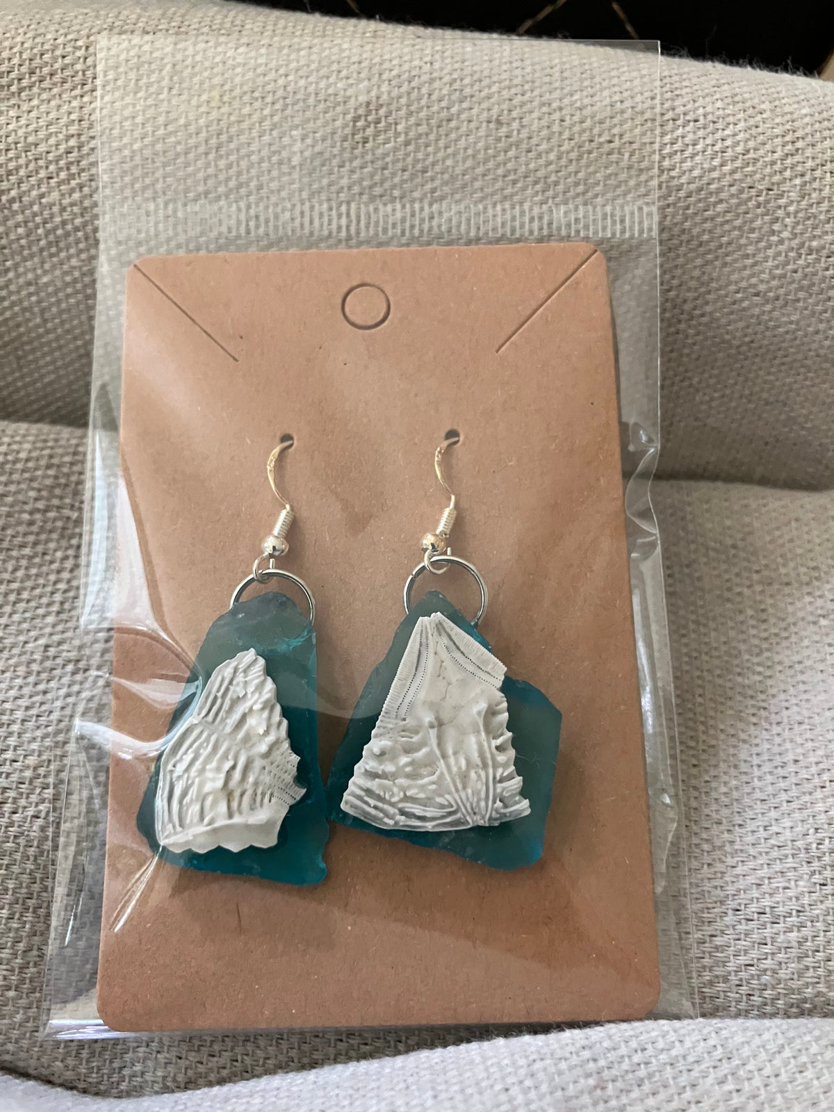 Blue sea glass and sand dollar piece earrings by Tonya Arnold